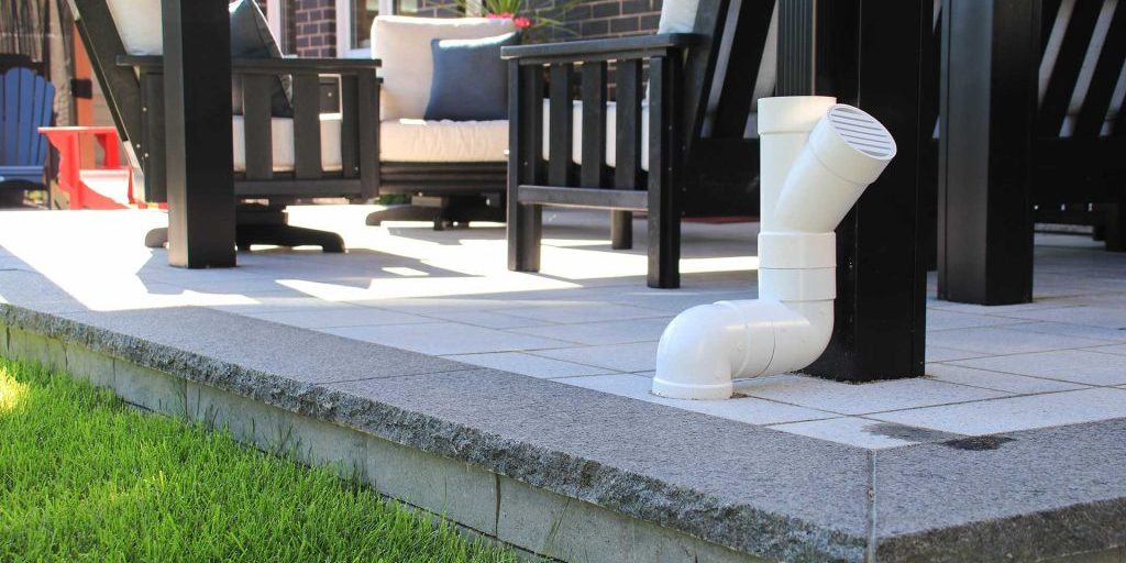 Raised interlocking patio with drainage solution